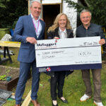 Giant cheque being handed over to charity