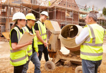 Partnership working tipped to help attract fresh talent Builder using cement mixer on site with apprentices