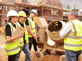 Partnership working tipped to help attract fresh talent Builder using cement mixer on site with apprentices