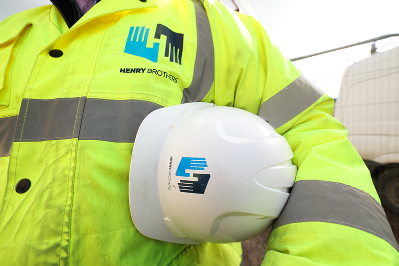 Construction worker with Henry Brothers branding